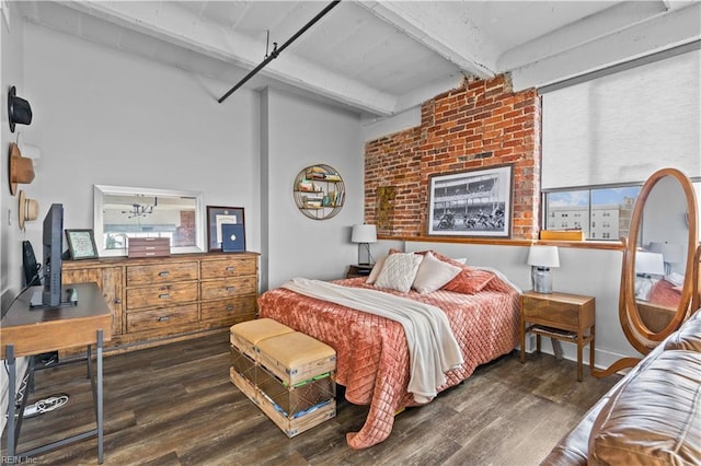 bedroom with beam ceiling and dark hardwood / wood-style flooring