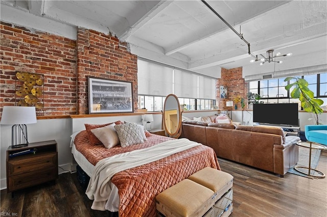 bedroom with dark hardwood / wood-style flooring, beamed ceiling, brick wall, and an inviting chandelier