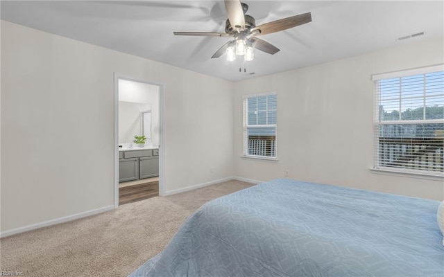 carpeted bedroom featuring connected bathroom and ceiling fan