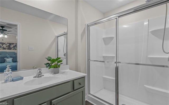 bathroom featuring vanity, ceiling fan, and a shower with shower door