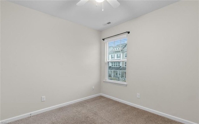 carpeted empty room featuring ceiling fan