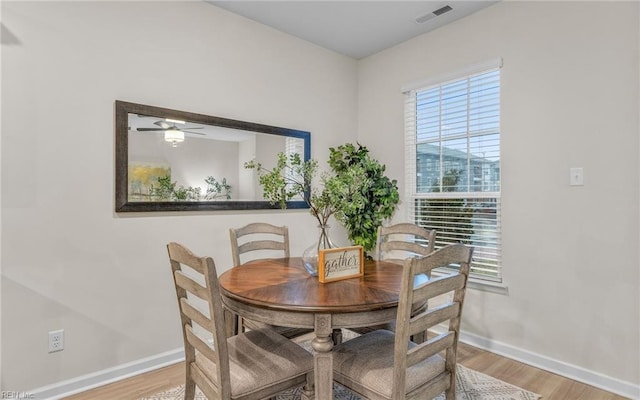 dining room with light hardwood / wood-style floors and ceiling fan