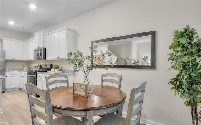 dining area with light hardwood / wood-style flooring