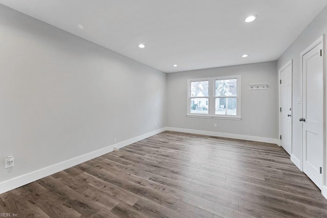 empty room with dark hardwood / wood-style flooring