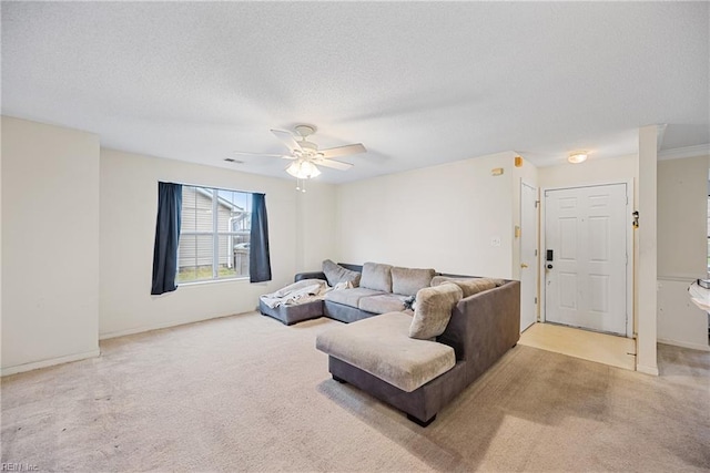 living room with a textured ceiling, ceiling fan, and light carpet