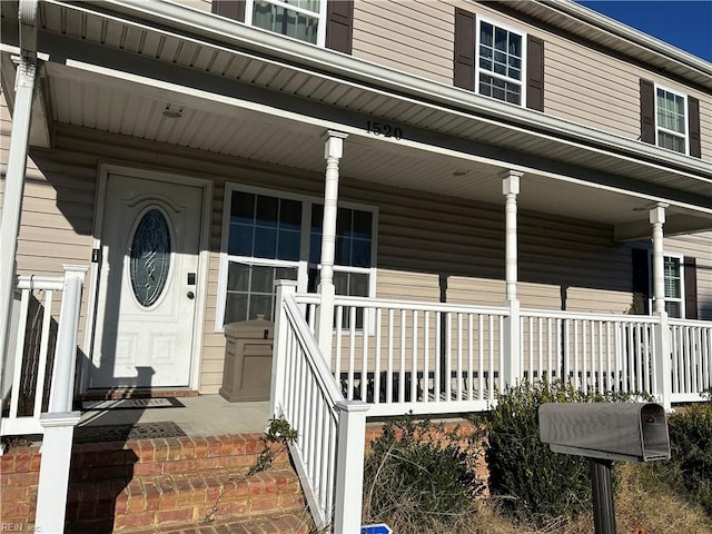 doorway to property featuring covered porch