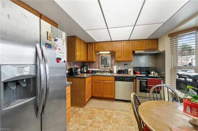 kitchen featuring tasteful backsplash, sink, and appliances with stainless steel finishes