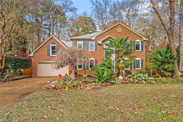 view of front facade with a front yard and a garage