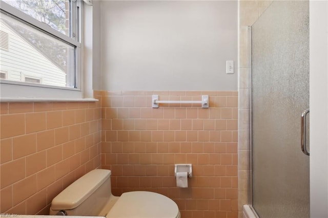 bathroom with an enclosed shower, toilet, and tile walls