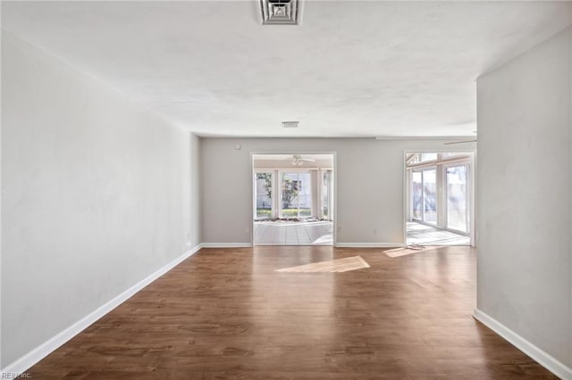 spare room featuring ceiling fan and dark hardwood / wood-style flooring