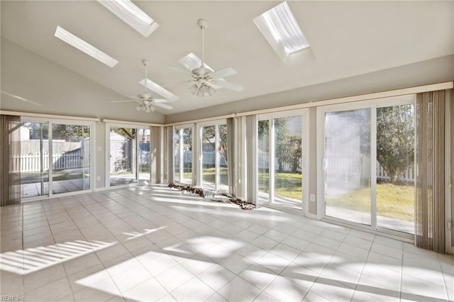 unfurnished sunroom with ceiling fan, a healthy amount of sunlight, and lofted ceiling with skylight