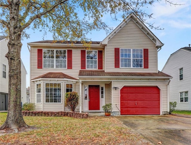 view of front of property with a front yard and a garage