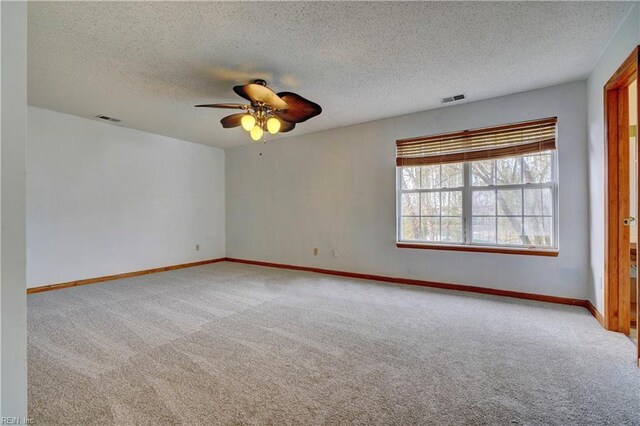 empty room featuring carpet, ceiling fan, and a textured ceiling