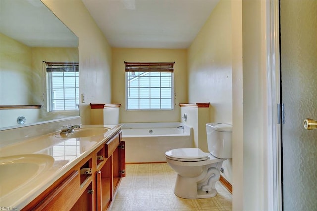 bathroom with a tub to relax in, vanity, and toilet