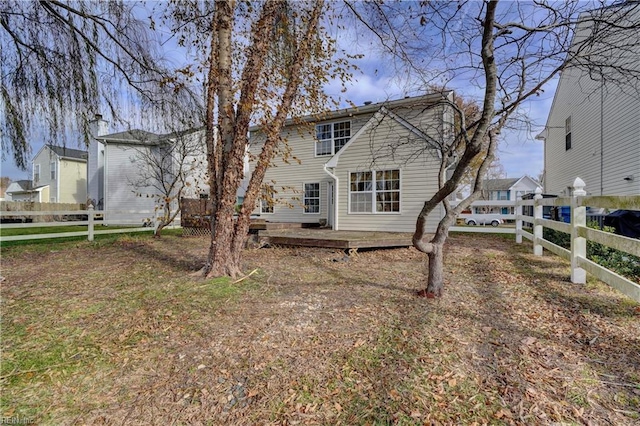 rear view of property featuring a wooden deck