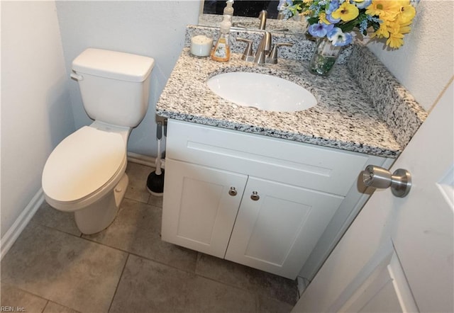 bathroom featuring tile patterned flooring, vanity, and toilet