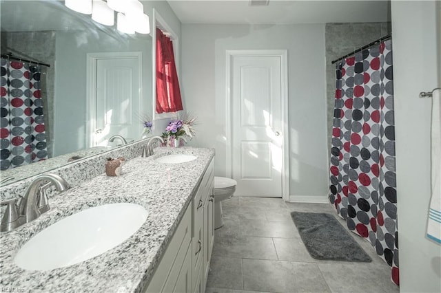 bathroom featuring tile patterned floors, vanity, curtained shower, and toilet