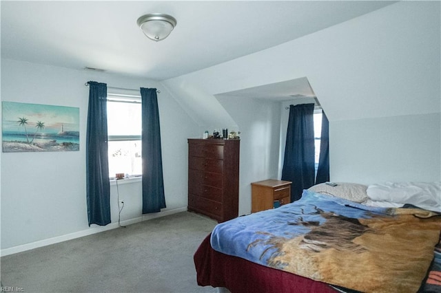 bedroom featuring light carpet and lofted ceiling