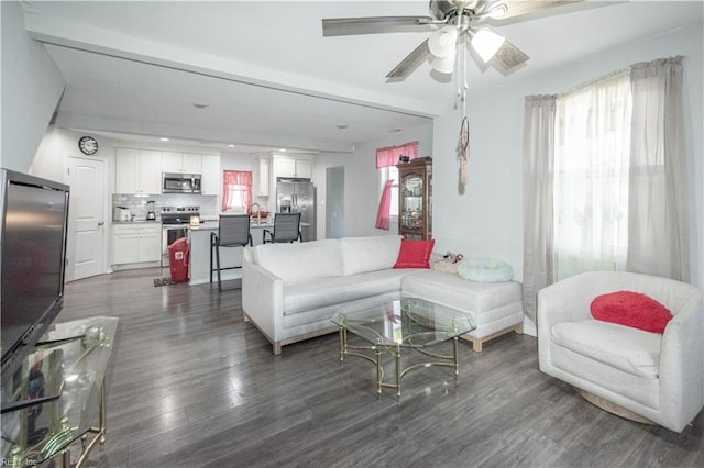 living room featuring ceiling fan and dark wood-type flooring