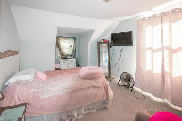 bedroom featuring light carpet and vaulted ceiling