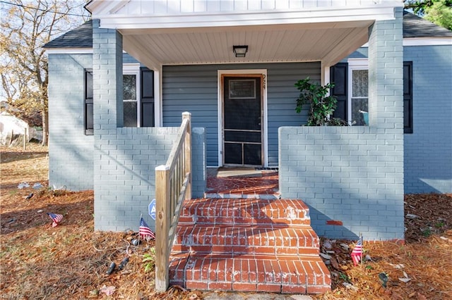 view of exterior entry with a porch