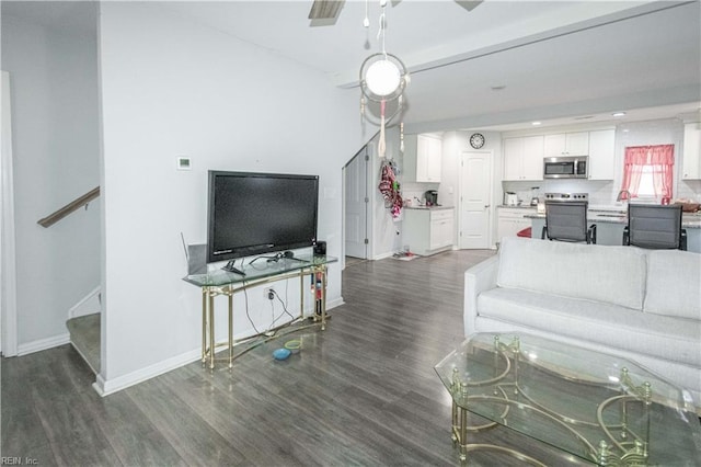 living room with ceiling fan and dark hardwood / wood-style floors