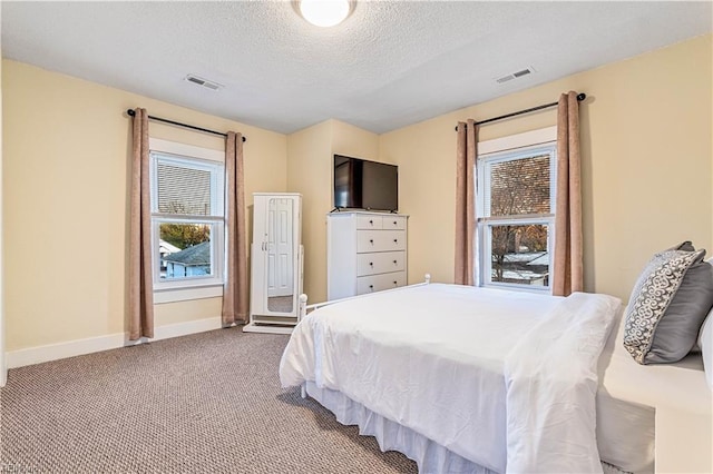 bedroom with carpet and a textured ceiling