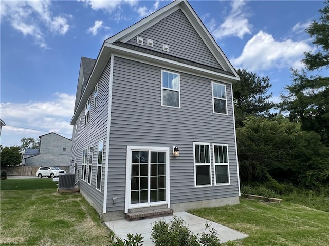 rear view of property with a patio area and a yard