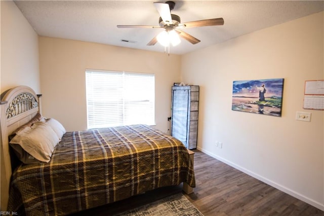 bedroom featuring dark hardwood / wood-style floors and ceiling fan