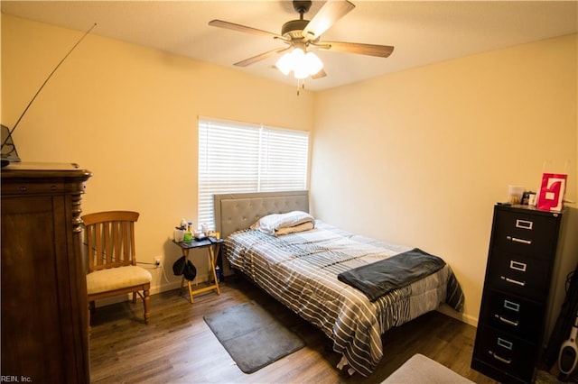 bedroom with ceiling fan and dark hardwood / wood-style flooring