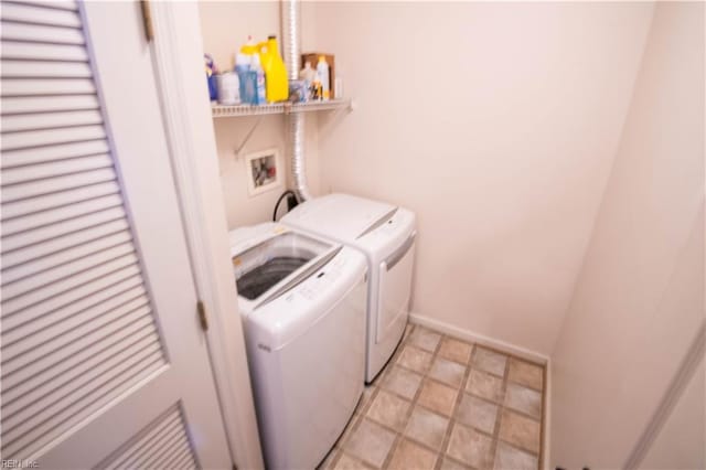 clothes washing area with separate washer and dryer