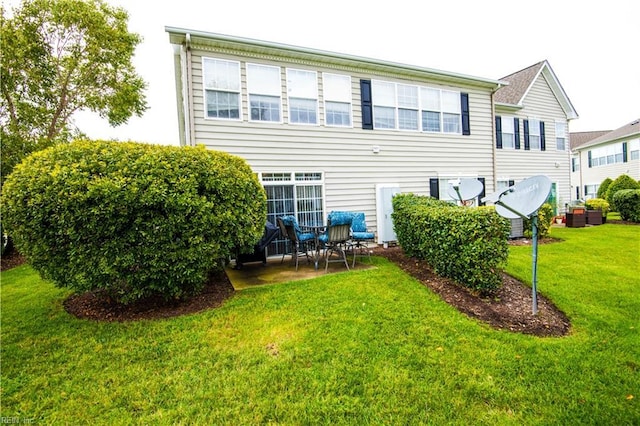 rear view of property featuring a yard