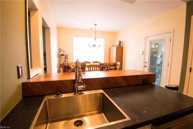 kitchen with sink, a chandelier, and decorative light fixtures