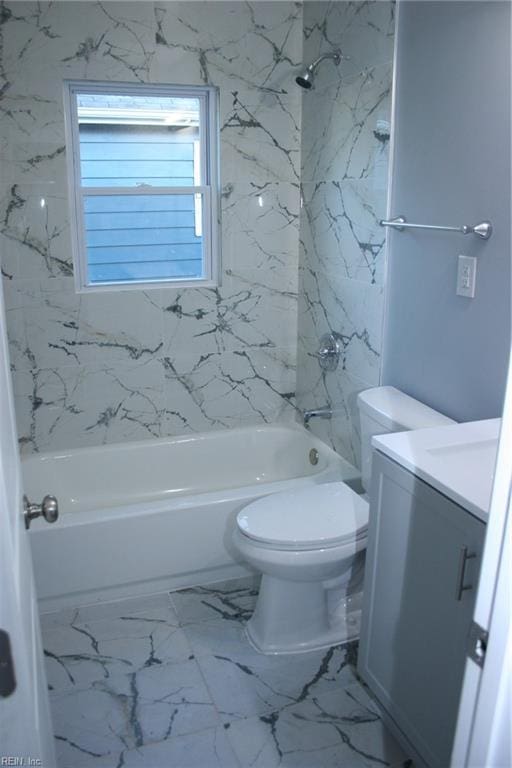 full bathroom with vanity, tiled shower / bath combo, and toilet