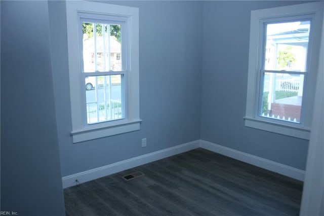 spare room featuring dark hardwood / wood-style flooring