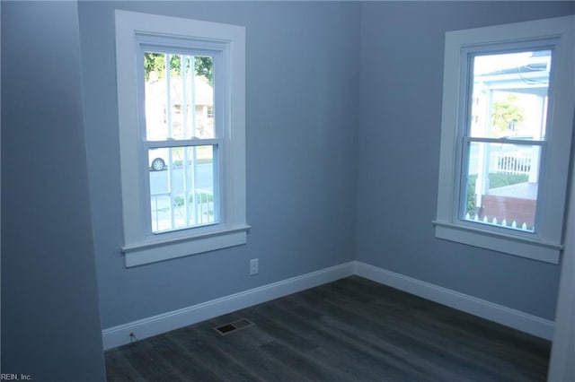 spare room with dark hardwood / wood-style flooring