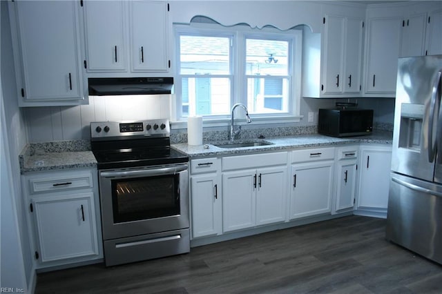 kitchen featuring white cabinets, sink, appliances with stainless steel finishes, and dark wood-type flooring