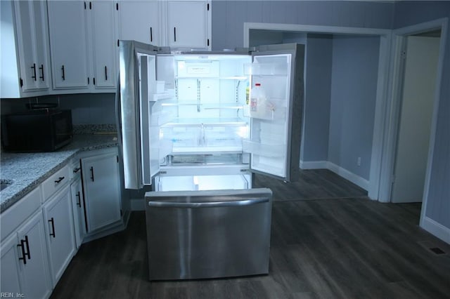 kitchen featuring light stone countertops, stainless steel fridge, dark hardwood / wood-style floors, and white cabinetry