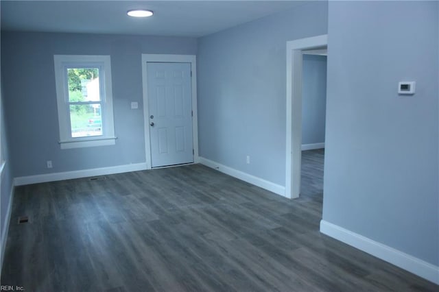 unfurnished room with dark hardwood / wood-style floors