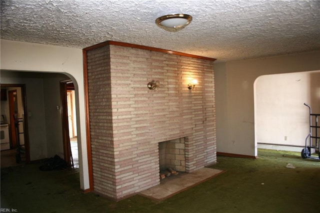 unfurnished living room featuring a fireplace and a textured ceiling