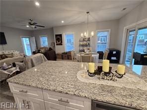 kitchen with light stone countertops and white cabinets