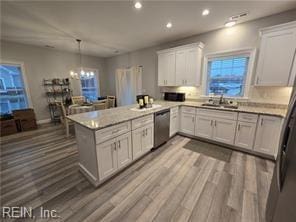 kitchen with sink, stainless steel dishwasher, kitchen peninsula, light hardwood / wood-style floors, and white cabinets