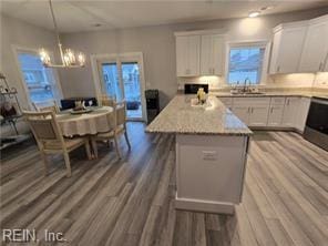 kitchen featuring dark hardwood / wood-style floors, a kitchen island, and white cabinetry