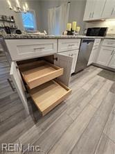 kitchen with white cabinetry, dishwasher, and light wood-type flooring