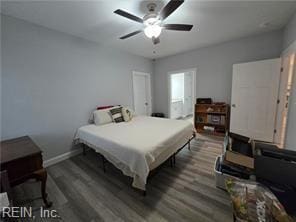 bedroom with dark hardwood / wood-style floors and ceiling fan