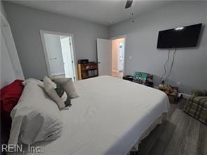 bedroom with dark hardwood / wood-style flooring and ceiling fan