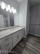 bathroom featuring a shower, wood-type flooring, and vanity