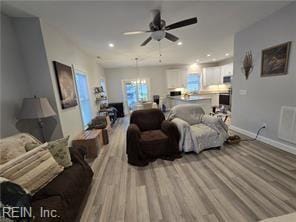 living room featuring ceiling fan and light wood-type flooring