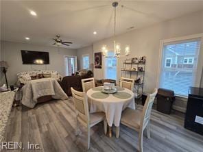 dining area featuring a wealth of natural light, ceiling fan, and wood-type flooring