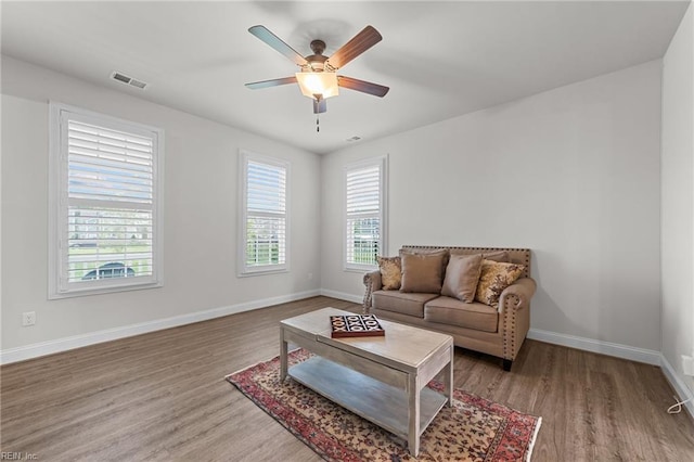 living room with hardwood / wood-style floors and ceiling fan